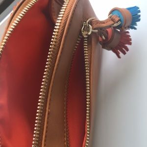 Faux leather wristlet "saddle" is the color, butterscotch-ish Fun orange lining